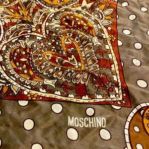 Well loved silk moschino scarf 32x32.  Has minor damage